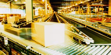Cardboard box on a conveyor belt in a fulfillment warehouse