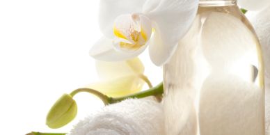 White orchid flower with a spa towel and bottle