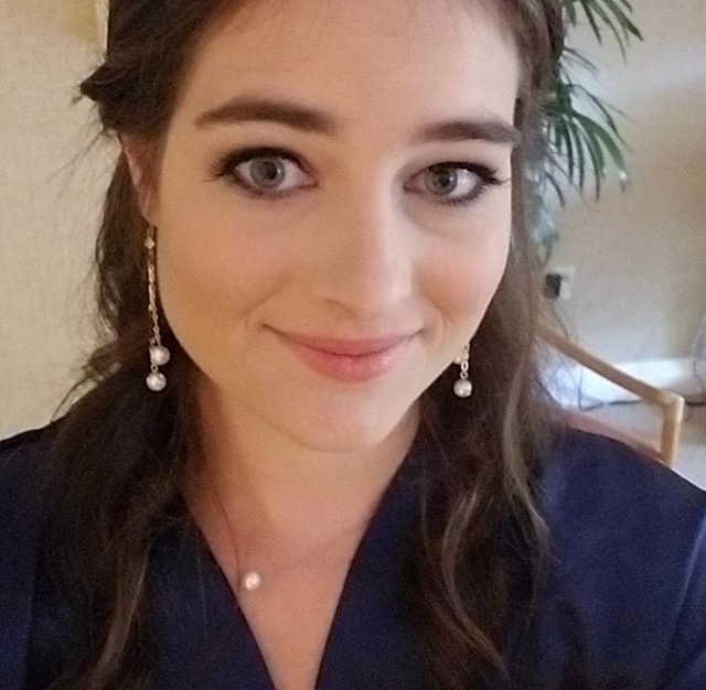 Sami McGuire, contributor, with pearl drop earrings and a navy top