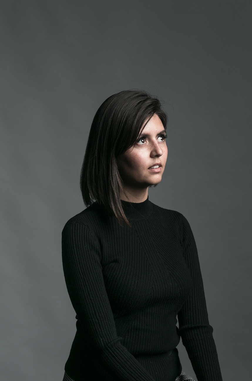 Goretti Campbell, founder of WDTnow, in a black turtleneck against a grey studio background