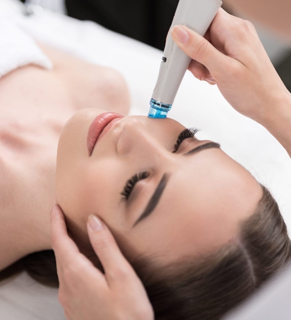 Woman receiving a HydraFacial treatment with a wand device near her eye