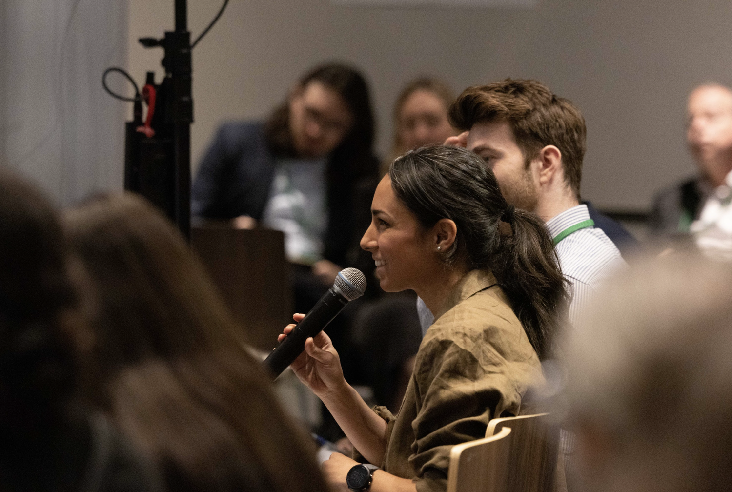 Speaker holding a microphone at a New York Climate Week session