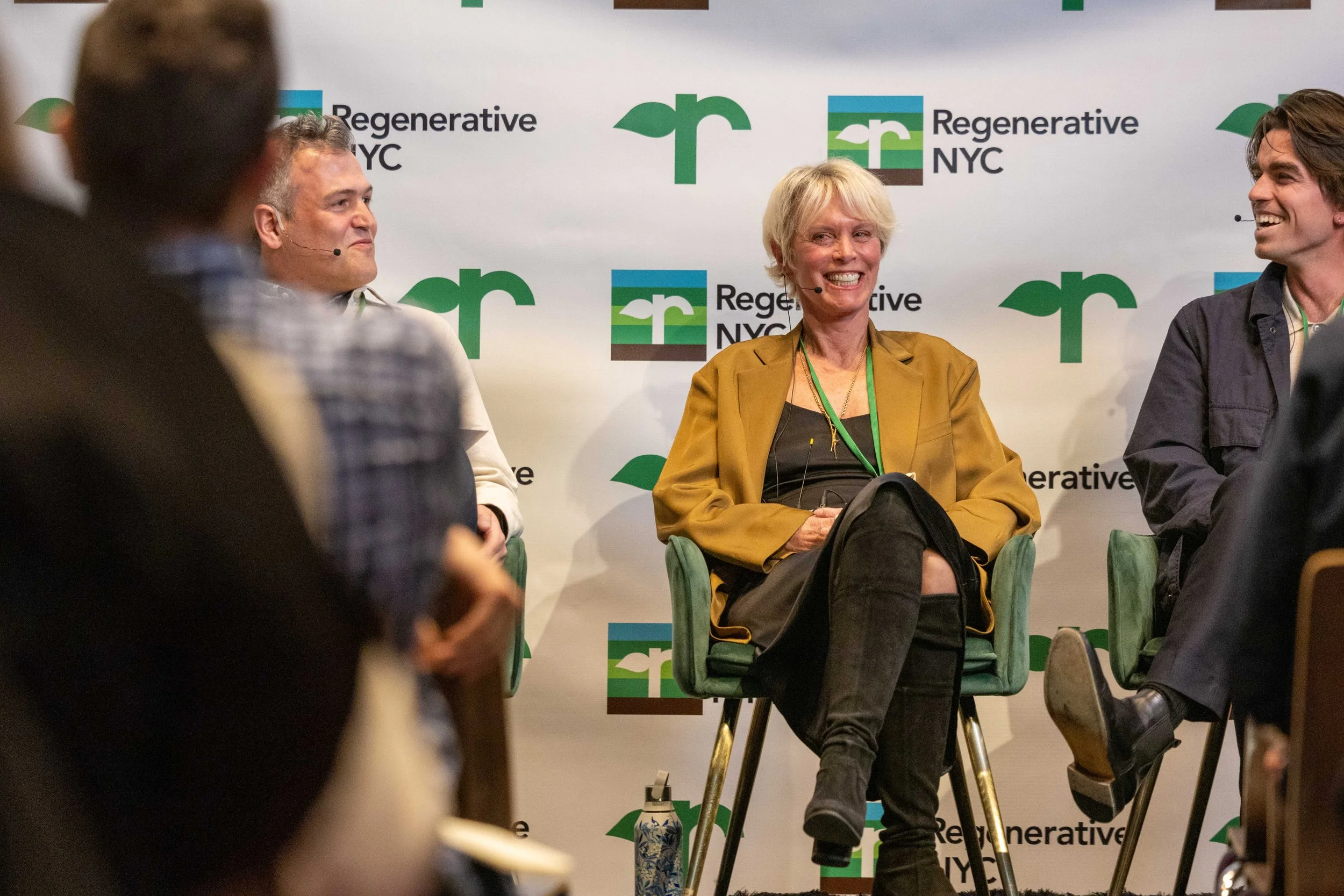 Panel discussion at RegenerativeNYC with three panelists seated on stage