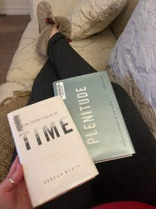 Person holding two books, Time and Plenitude