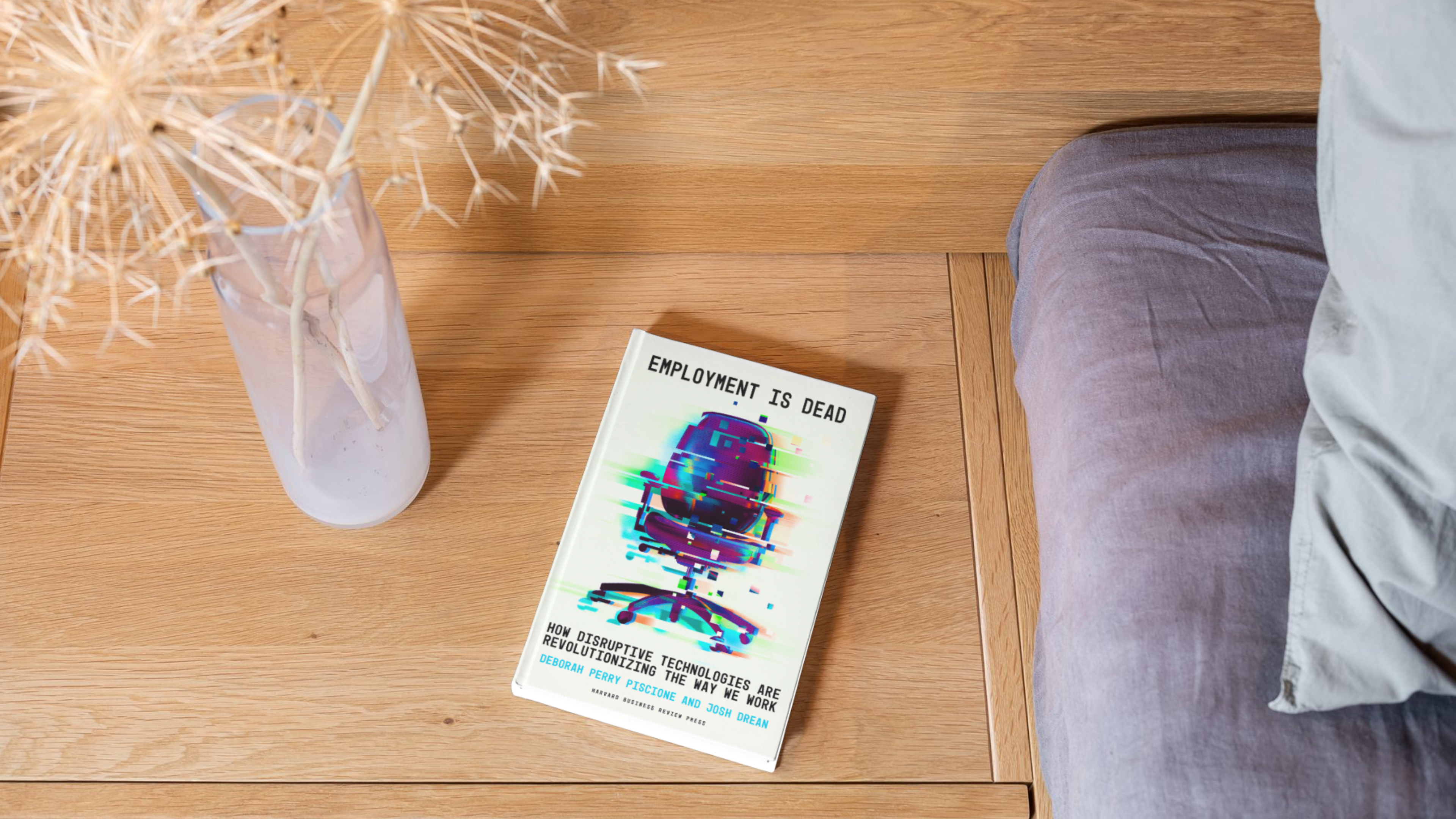 Employment Is Dead book resting on a wooden surface