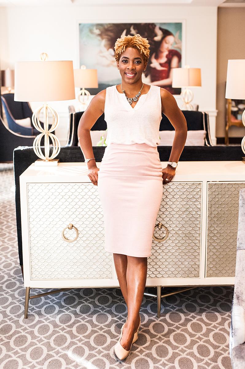 Portrait of Farah Harris, founder of WorkingWell Daily, standing in a hotel lobby