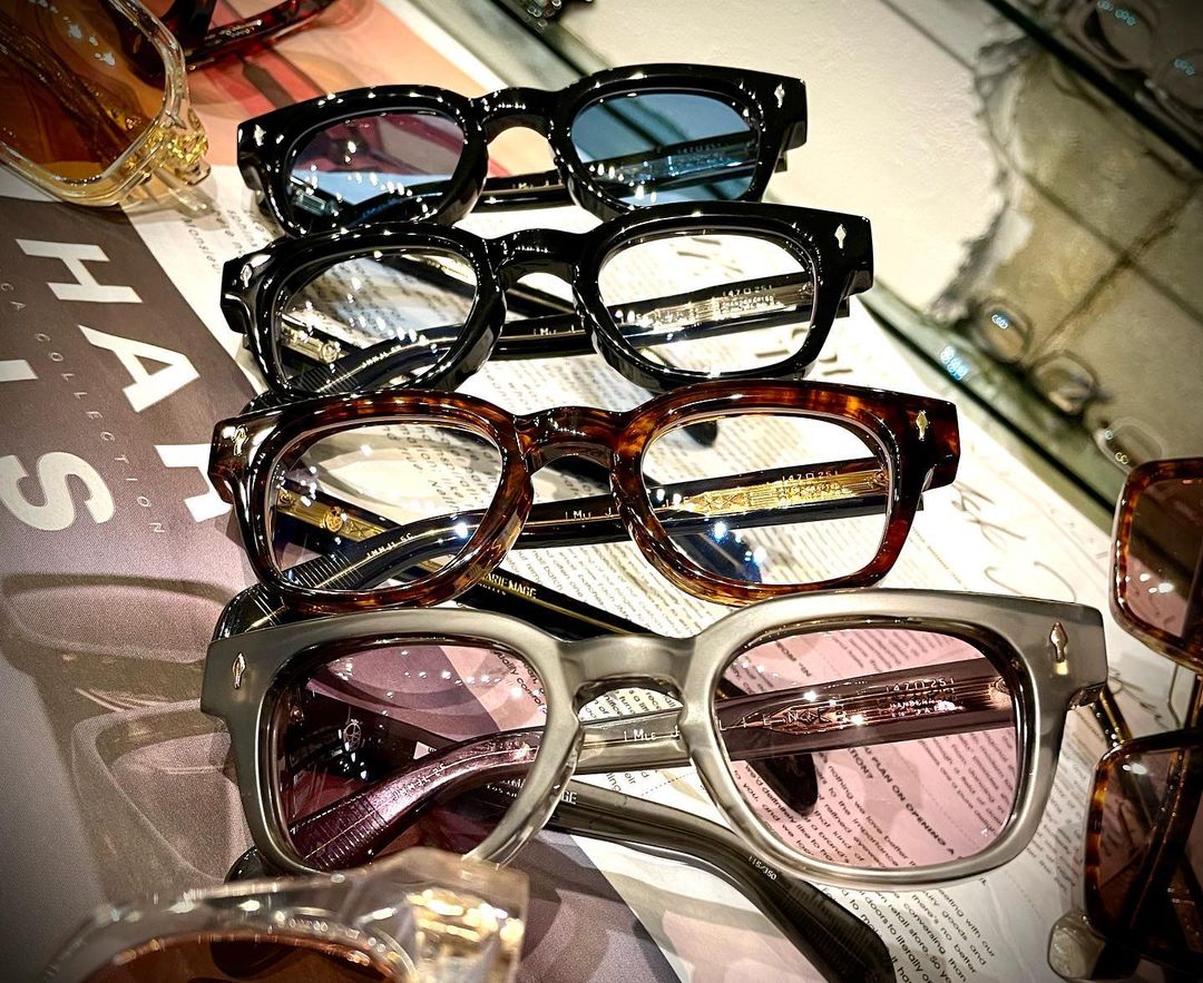 Designer frames arranged on a glass surface in the shop