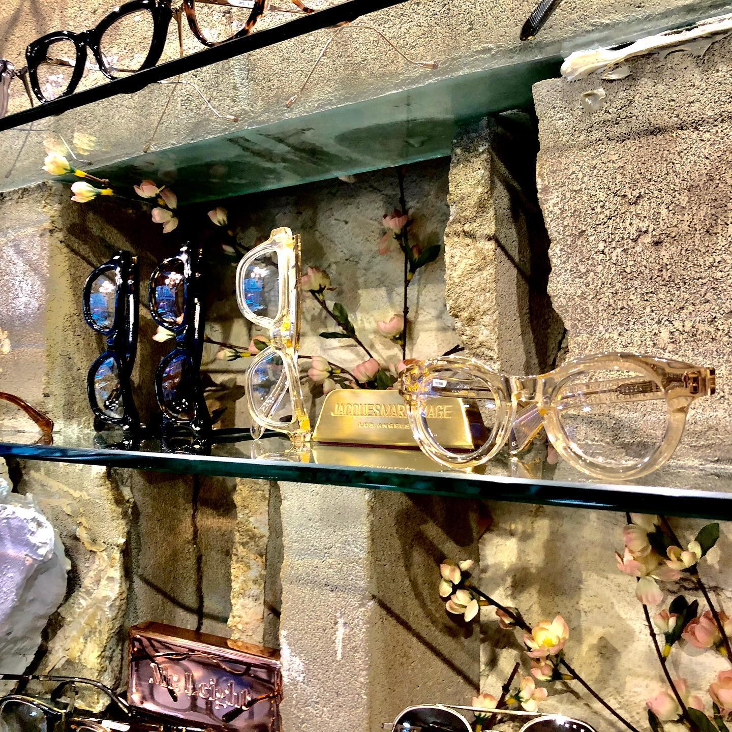 A stack of tortoiseshell and acetate frames on the counter