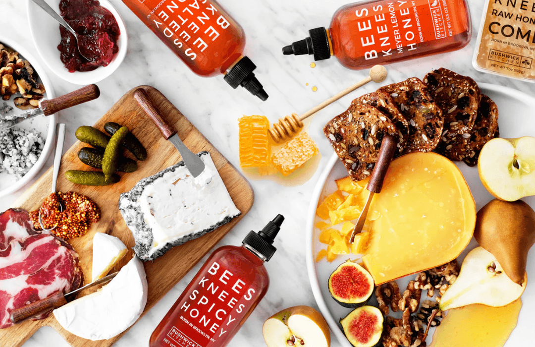 Bees Knees Spicy Honey bottles arranged on a cheese board