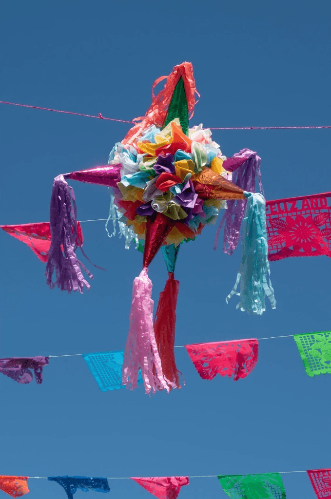 Colorful Mexican piñata against a bright blue sky