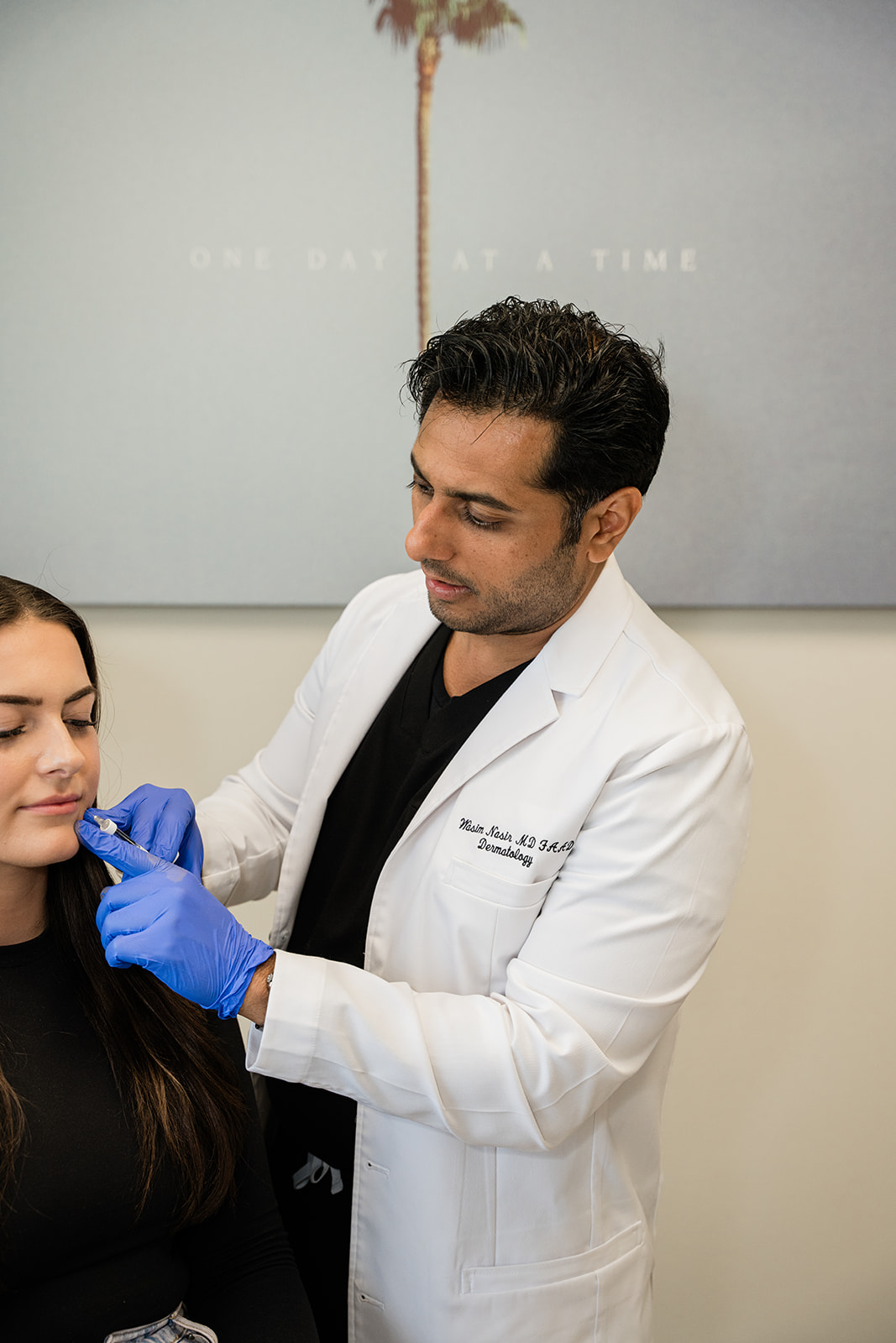 Dr. Wasim Nasir administering an injectable treatment to a patient