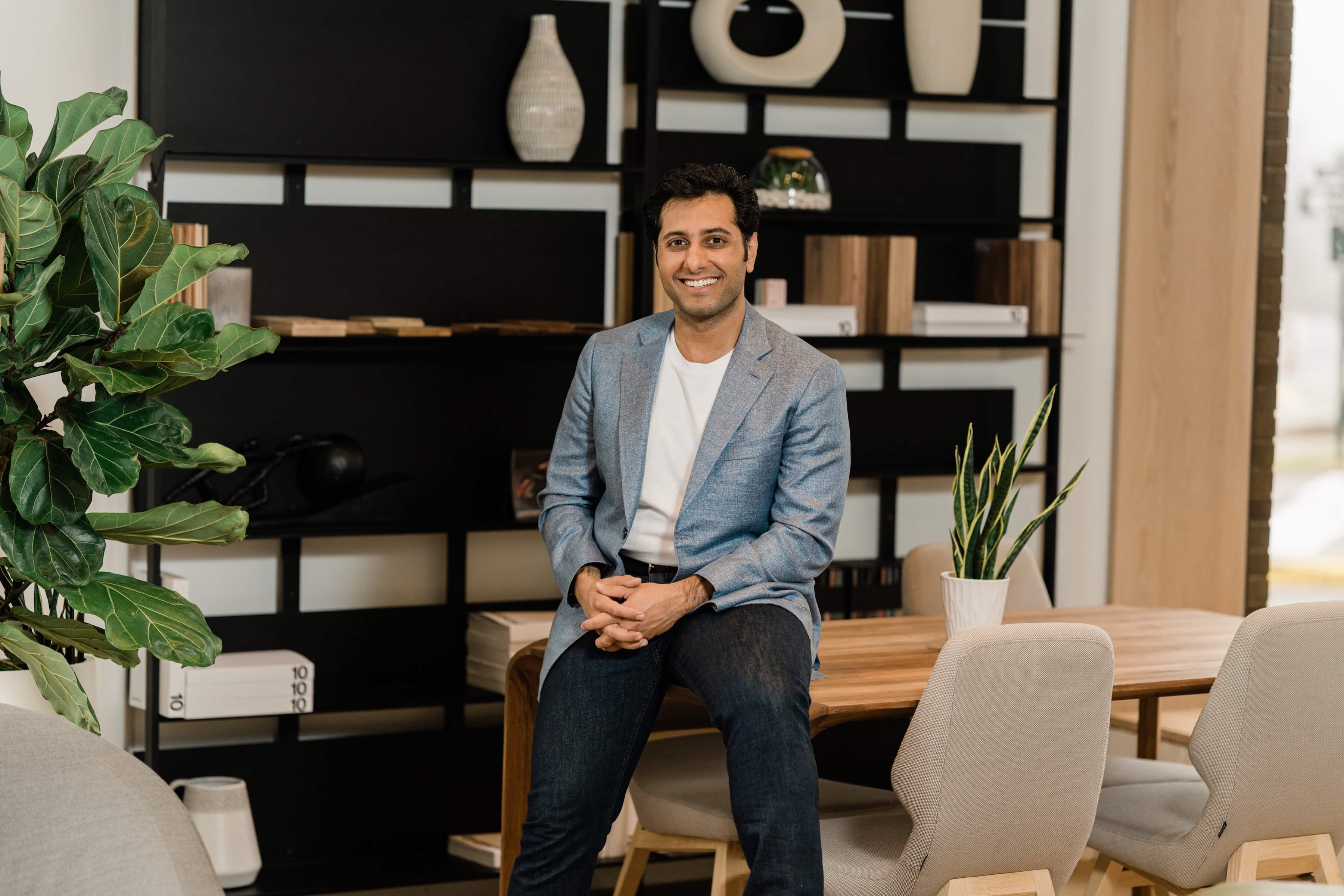 Dr. Wasim Nasir seated in the modern Dermatology & Cosmetic Center office