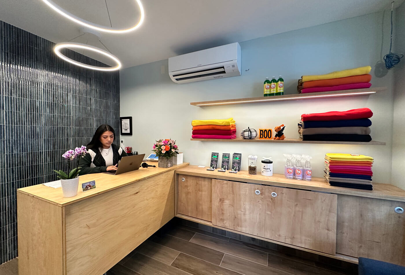 DOGMA front desk with a receptionist and shelves of colourful towels