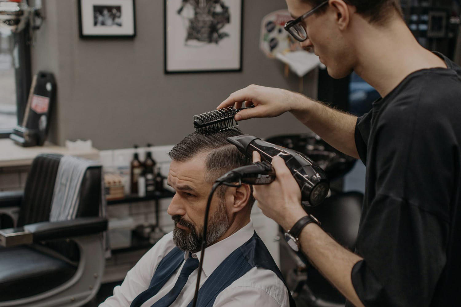 Barber cutting a client's hair at Elegant G Barber Shop.
