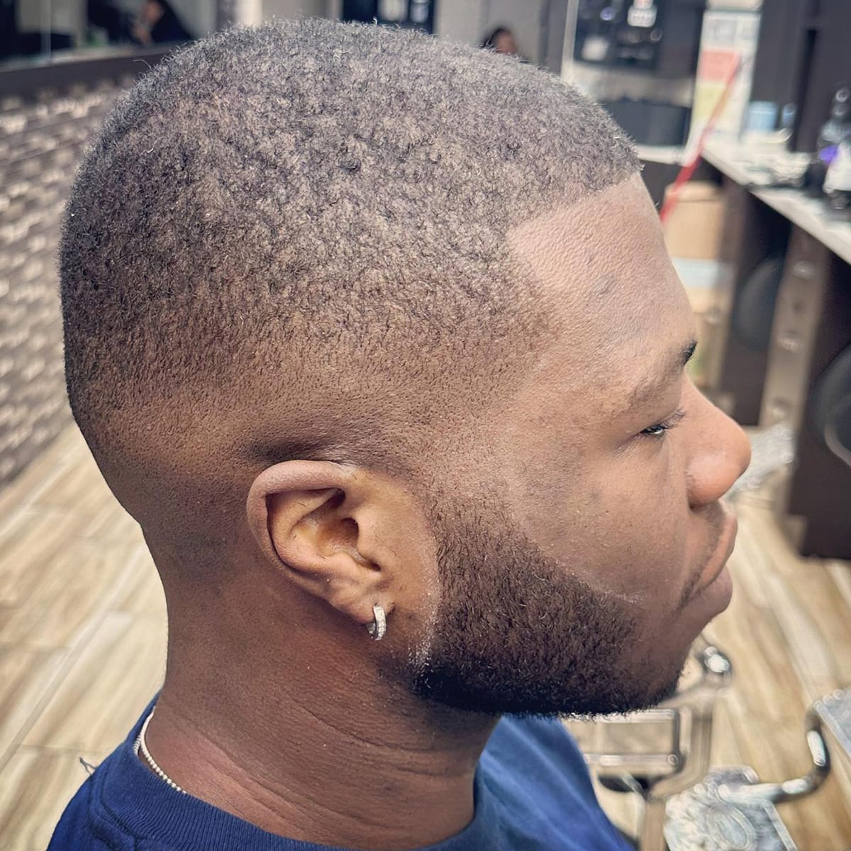 Side profile of a short buzz cut with skin fade inside the barbershop