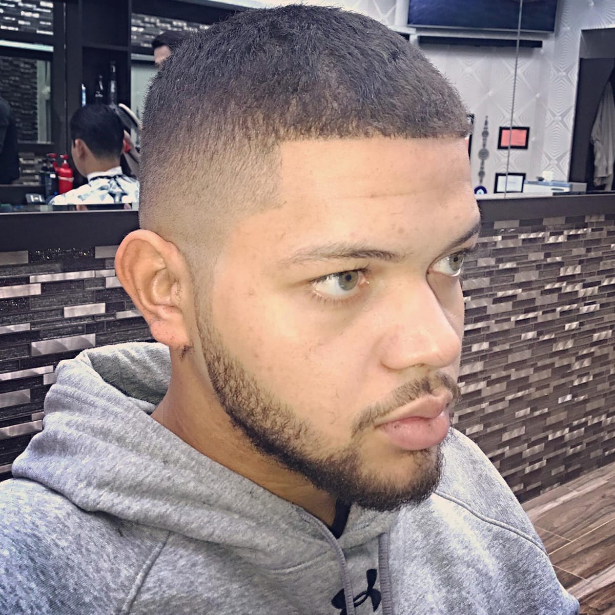 Front-facing close-up of a buzz cut with high fade and short beard