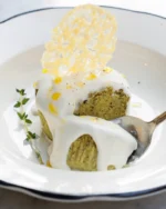 Instagram post: green sformatino with cream and thyme on a white plate