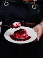 Instagram post: panna cotta with berry sauce being served