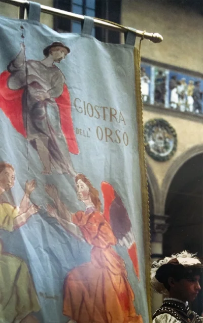 Painted medieval banner reading Giostra dell'Orso at a Pistoia historical festival