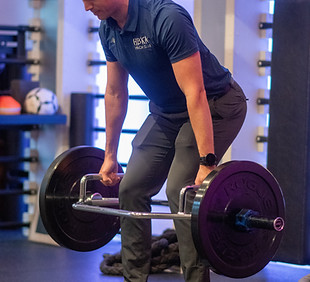 Athlete performing a barbell deadlift