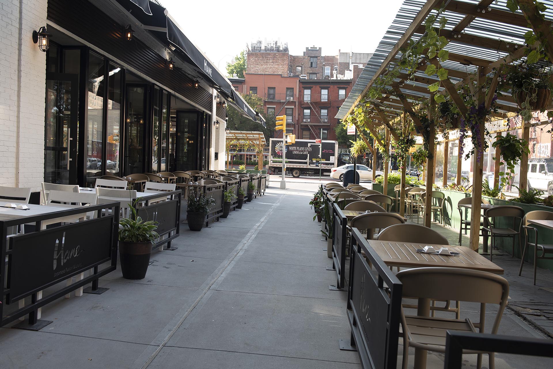 Hane outdoor patio and sidewalk seating under the pergola in daylight