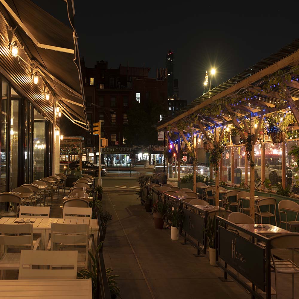 Hane outdoor patio and pergola at night with string lights