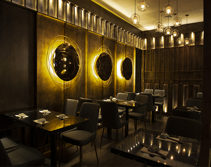 Hane dining room with signature gold circular wall art and pendant globe lights