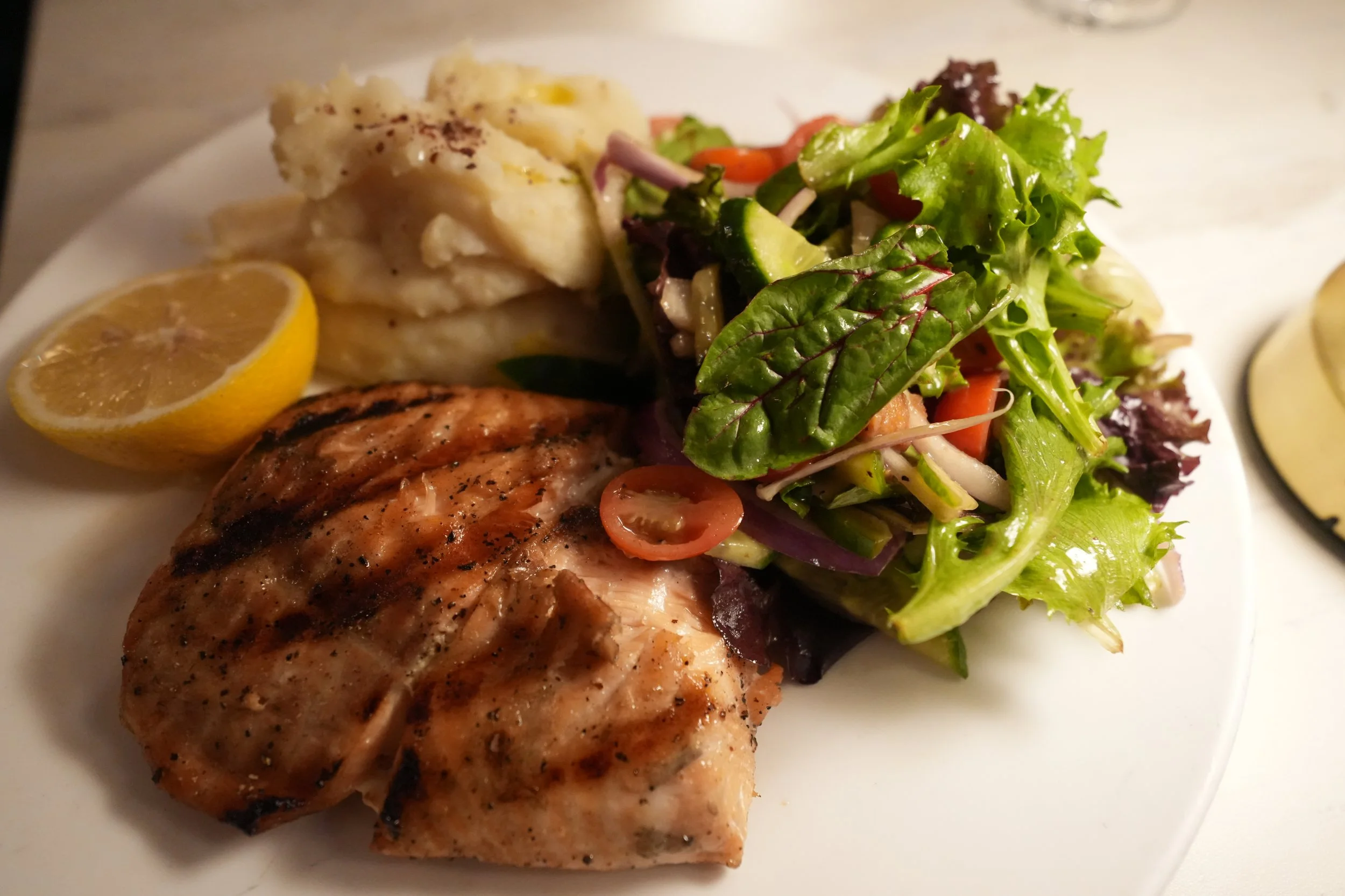 Grilled salmon with mashed potatoes and mixed greens
