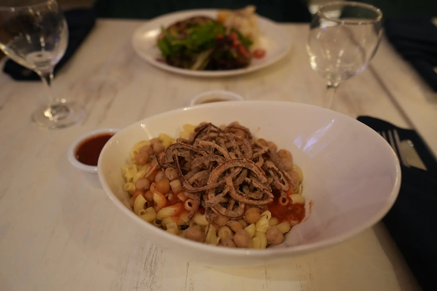 Bowl of koshari topped with crispy fried onions