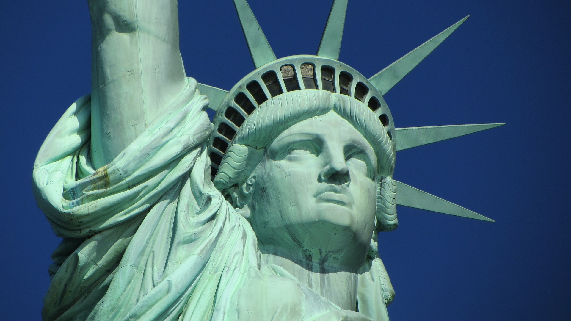 Close-up of the Statue of Liberty against a blue sky