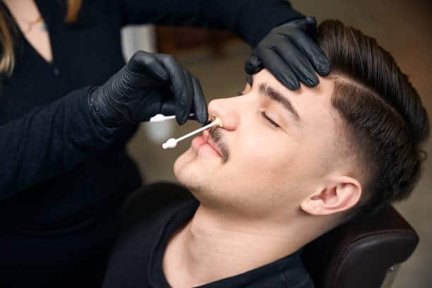 Nose wax applicator being used on a client