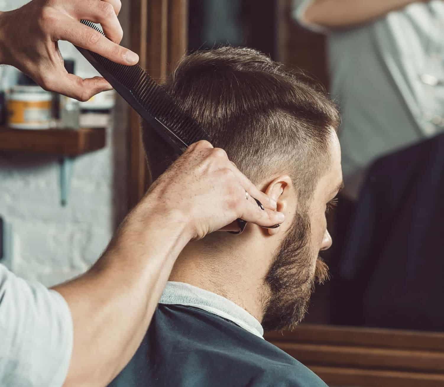 Barber combing and styling a client's hair