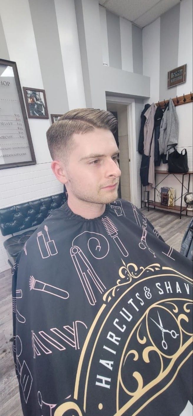 Client with a side-swept fade haircut