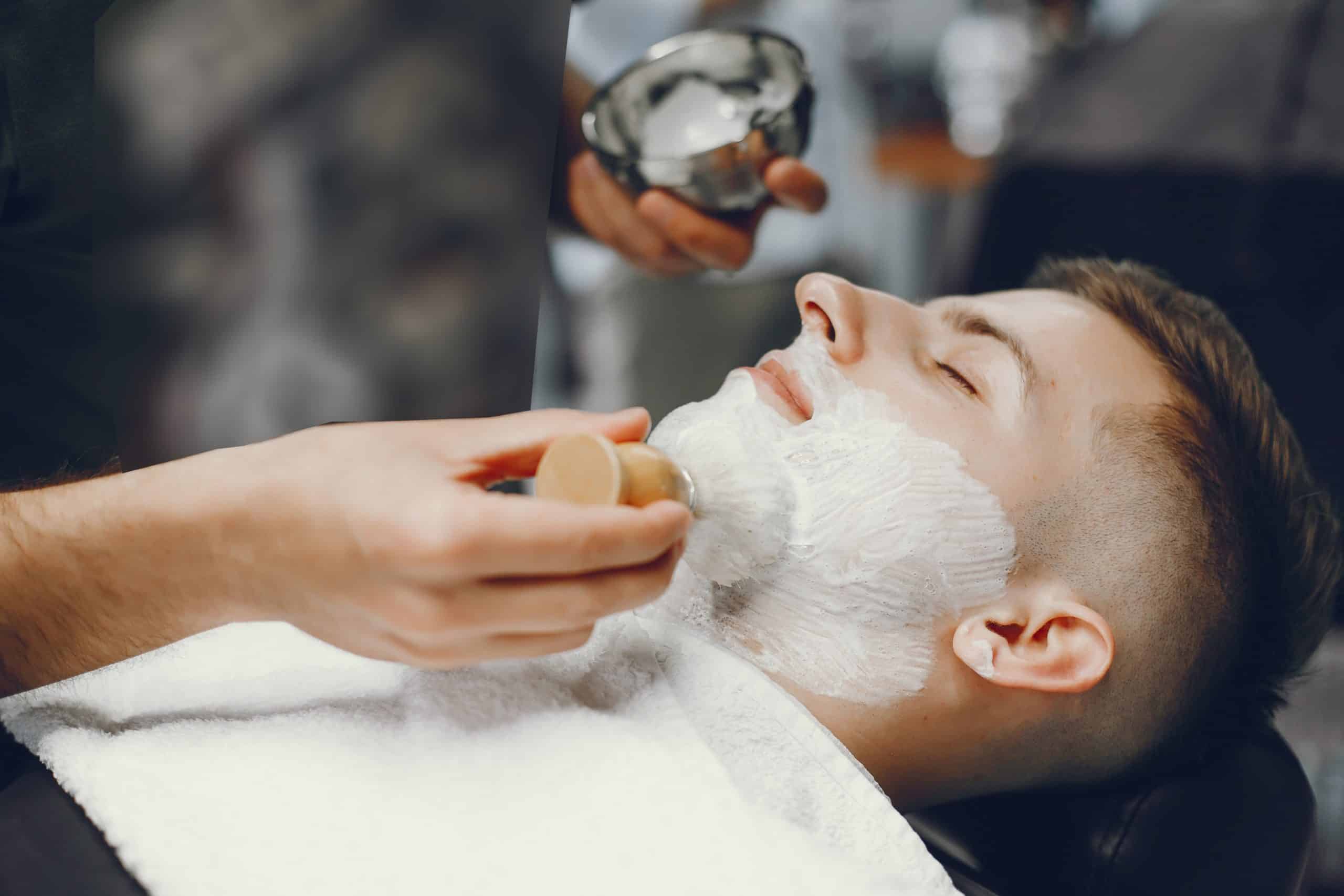 Barber applying shaving cream with a brush