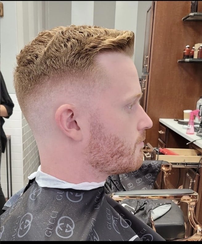Client profile with a curly blonde textured fade