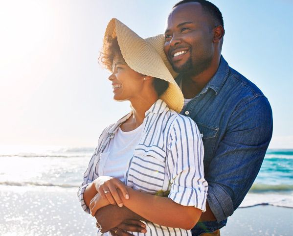 Happy couple embracing on a sunny beach