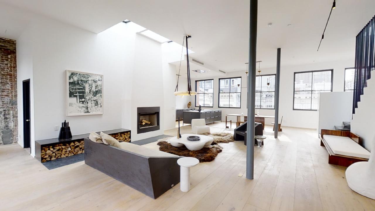 Modern luxury loft apartment interior with skylights, fireplace, open kitchen and designer furniture