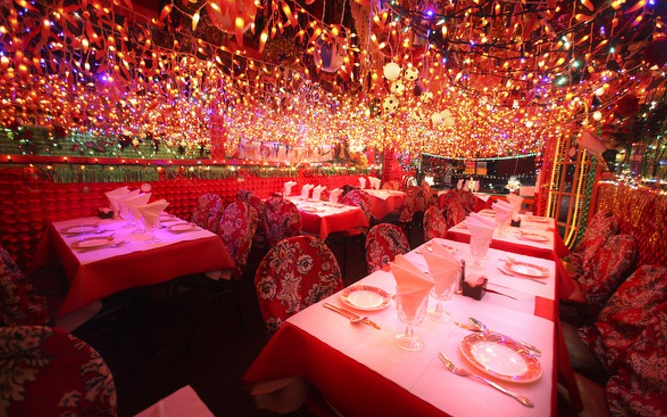 Panna II dining room with red tables beneath the full lit ceiling display