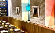 Thumbnail of the Pylos interior with colorful panels, wine rack wall and striped banquette
