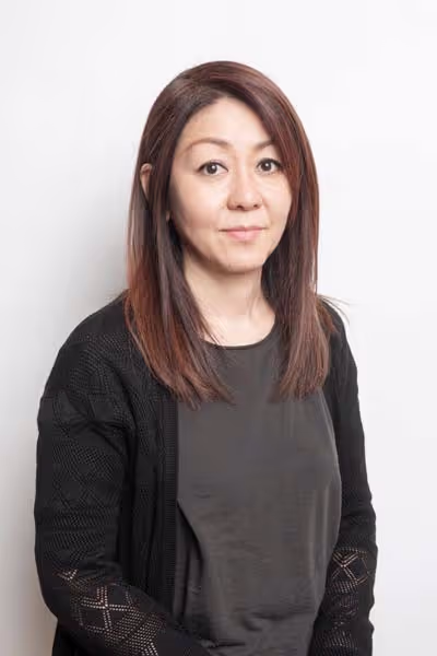 Aki, Redge Salons stylist, studio portrait on a white background