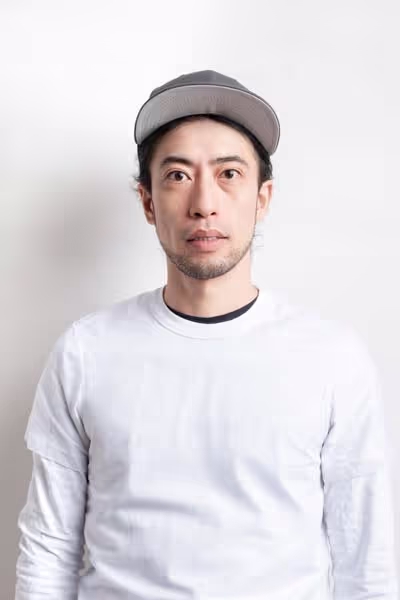 Toshi, Redge Salons stylist, studio portrait on a white background
