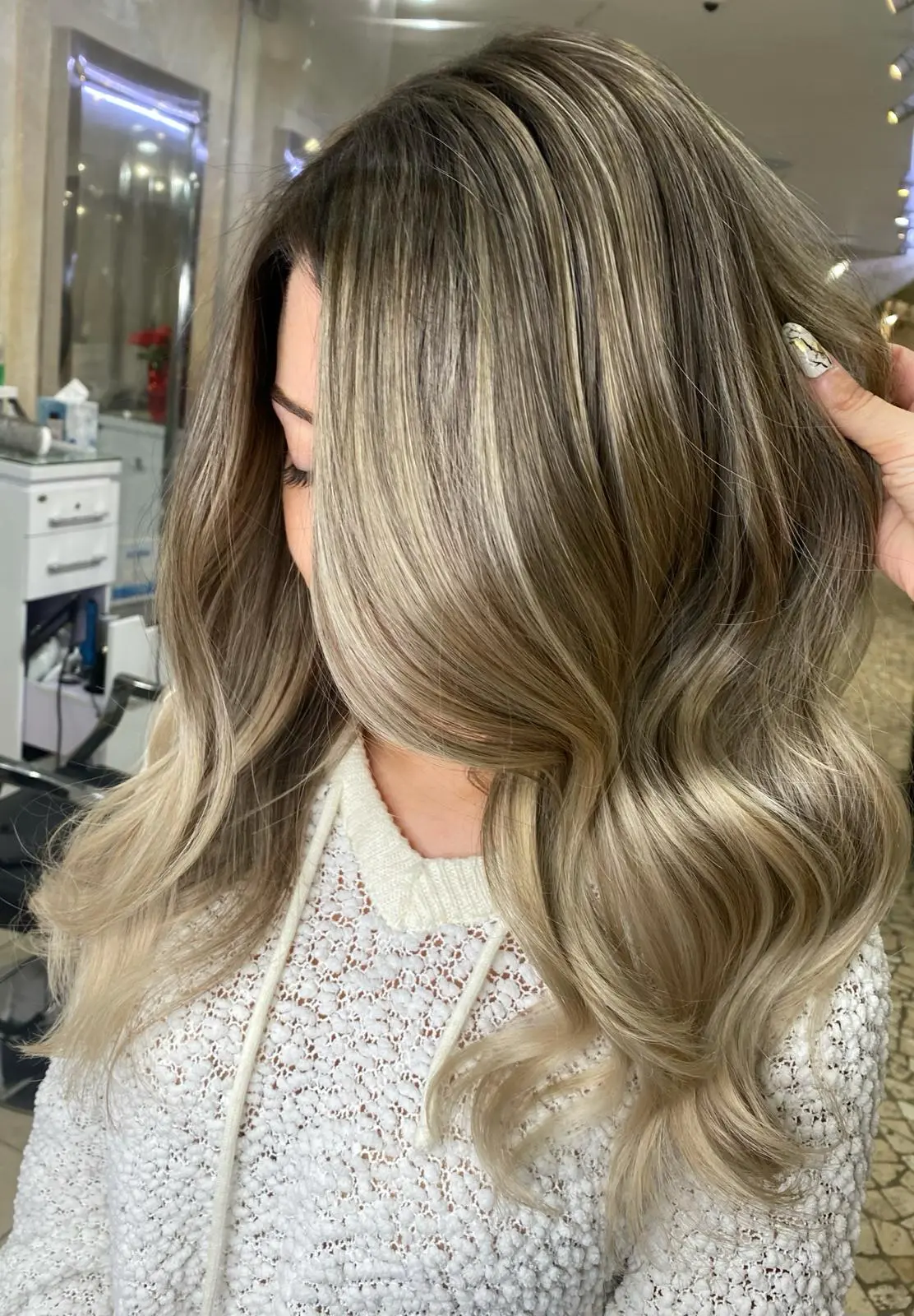 Client with brunette to ash blonde balayage highlights