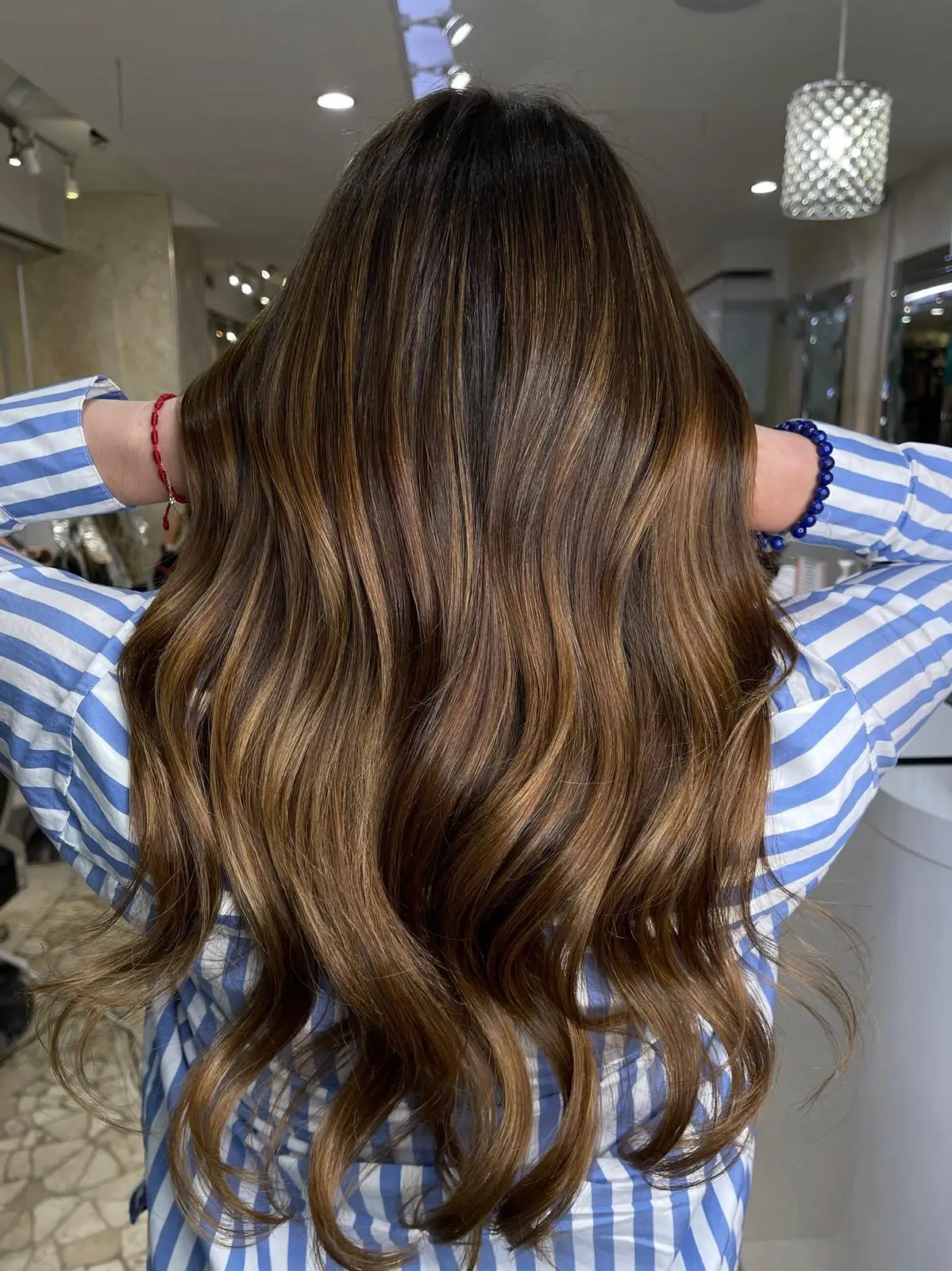 Client with long dark brown balayage waves