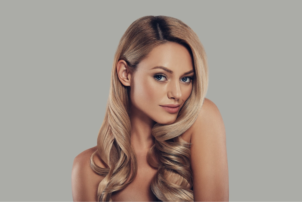 Client with long curly blonde hair smiling