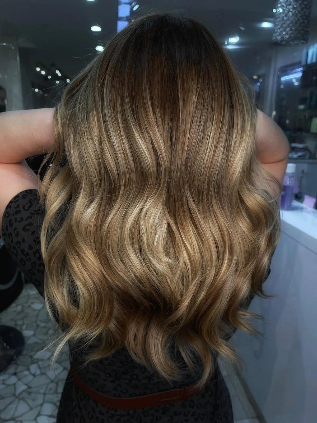 Back view of warm blonde balayage waves