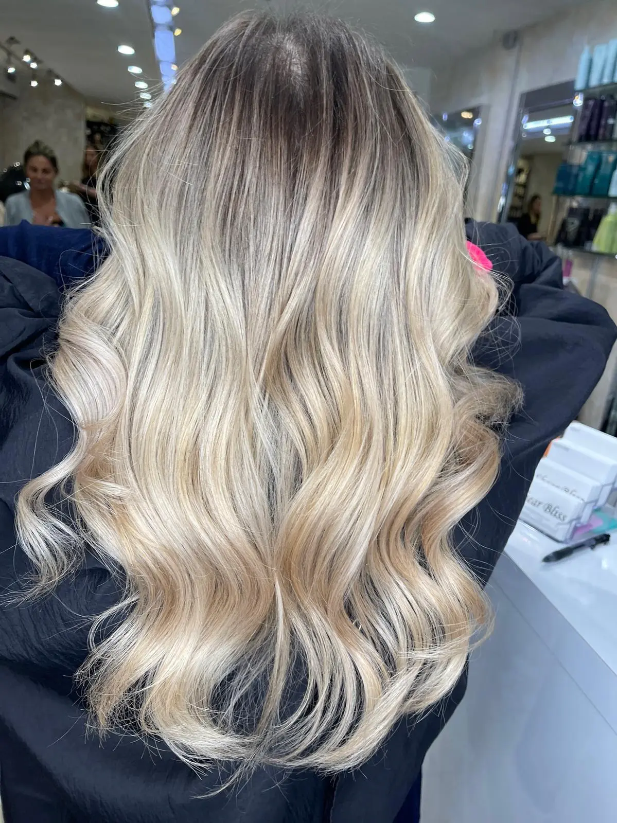 Client with long platinum blonde AirTouch balayage