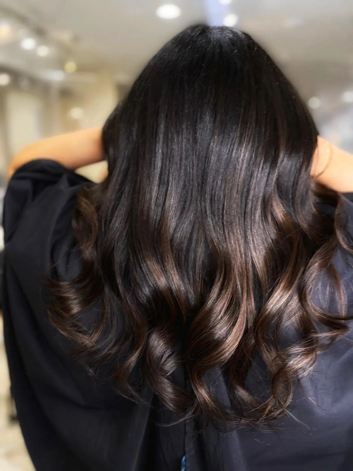 Dark hair with subtle bronze balayage highlights