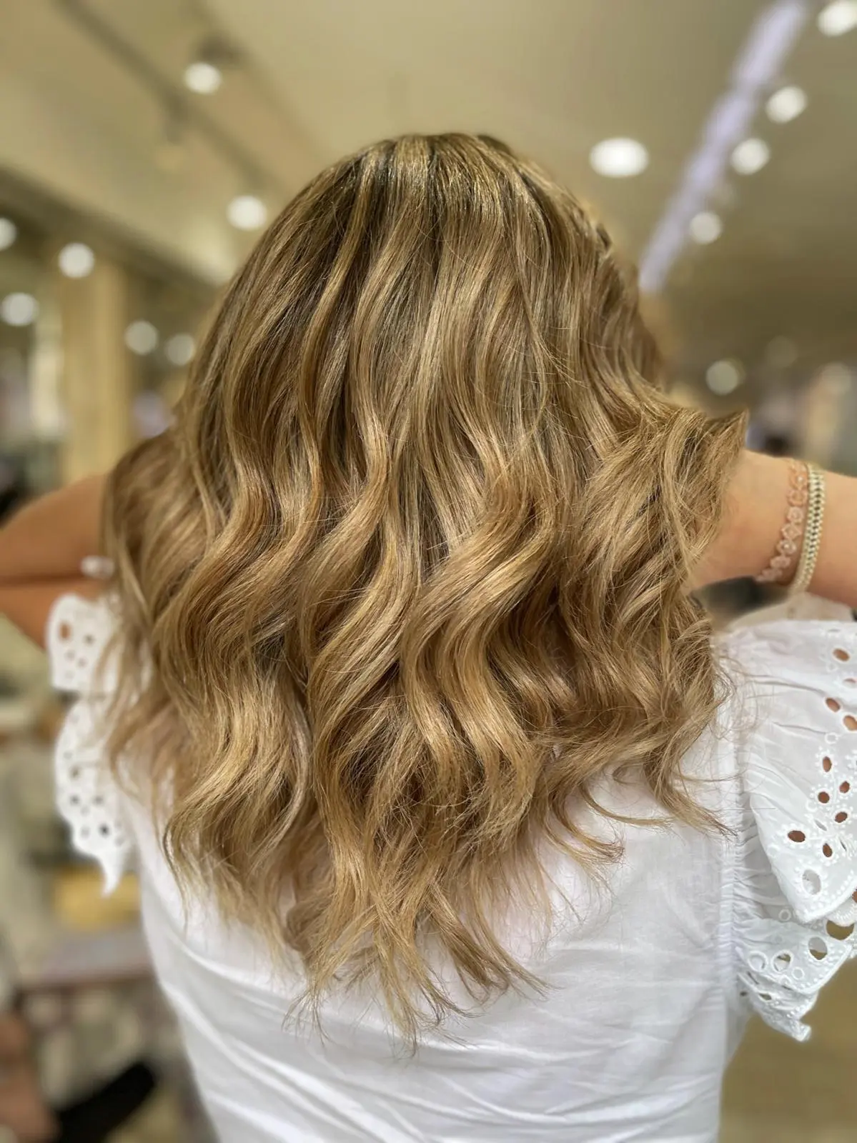 Golden bronde wavy hair, white eyelet top