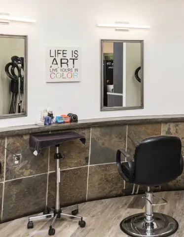 Shear Bliss NYC salon interior with styling chair, mirrors and 'Life is Art' wall art