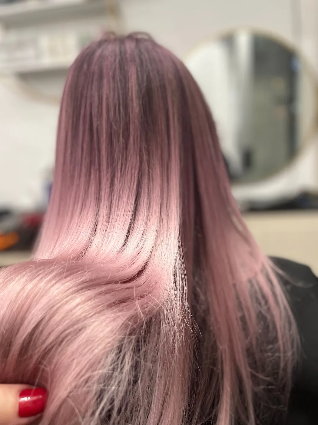 Back view of long straight pink-mauve fashion colored hair